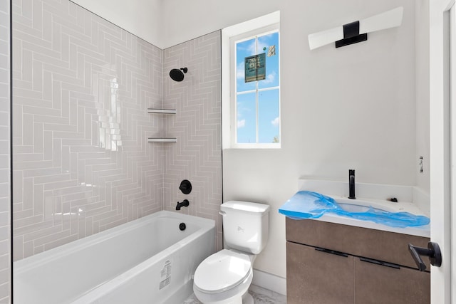 full bathroom featuring vanity, tiled shower / bath combo, and toilet