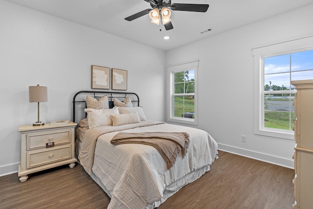 bedroom featuring dark wood-style flooring, visible vents, and baseboards