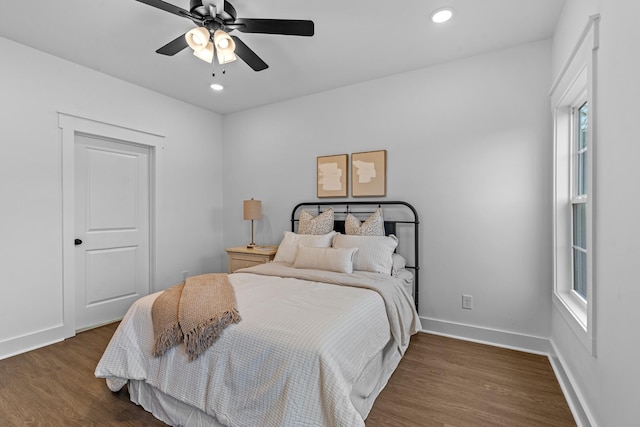 bedroom featuring dark wood-type flooring, recessed lighting, and baseboards