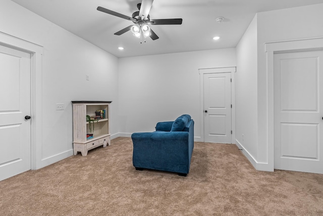 living area featuring carpet, baseboards, and recessed lighting