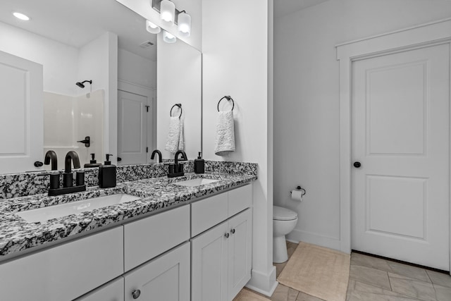 bathroom featuring visible vents, walk in shower, a sink, and toilet