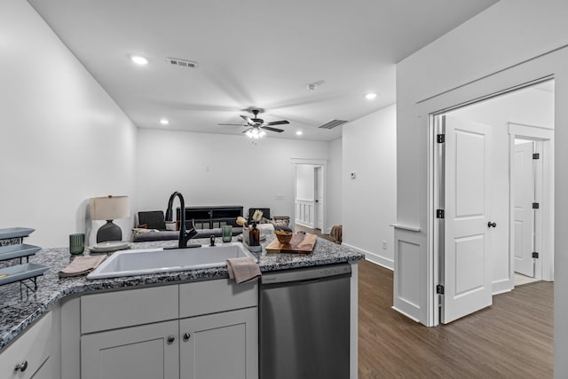 kitchen featuring stainless steel dishwasher, dark wood-style flooring, a sink, and visible vents