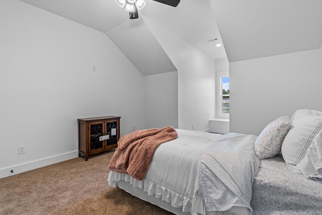 bedroom featuring ceiling fan, carpet, baseboards, and vaulted ceiling