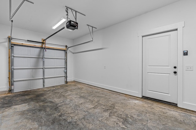 garage with baseboards and a garage door opener