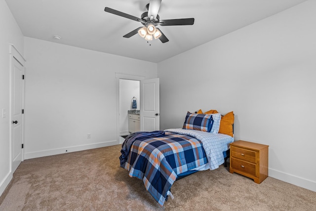 bedroom featuring ceiling fan, ensuite bath, carpet flooring, and baseboards