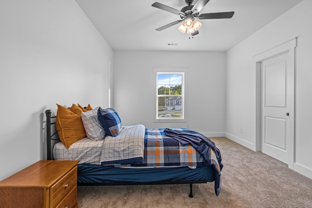 bedroom with ceiling fan, carpet, and baseboards