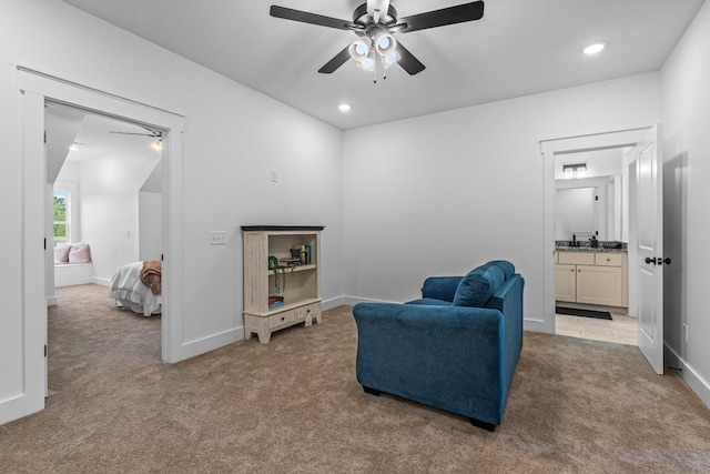 living area featuring baseboards, ceiling fan, recessed lighting, and light colored carpet