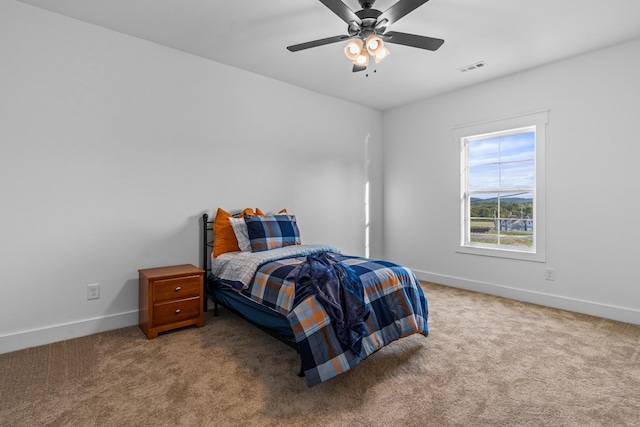 bedroom featuring carpet flooring, ceiling fan, visible vents, and baseboards