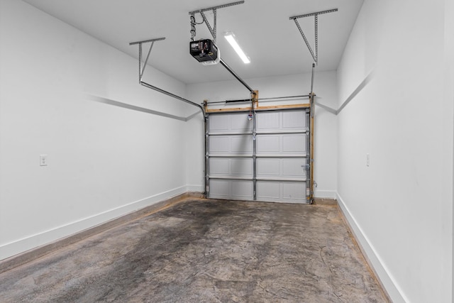 garage with a garage door opener and baseboards