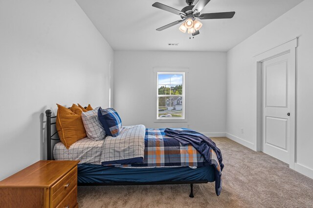 bedroom with ceiling fan, carpet, and baseboards