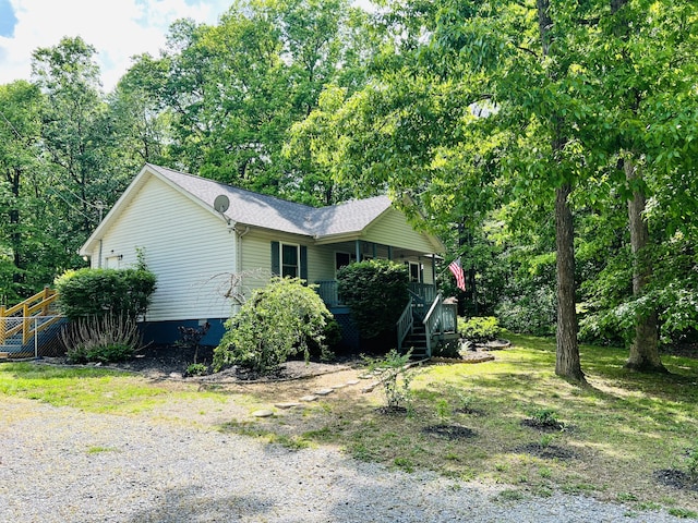 view of side of property with covered porch