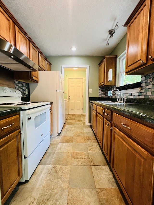 kitchen featuring electric stove, track lighting, a textured ceiling, wall chimney exhaust hood, and sink