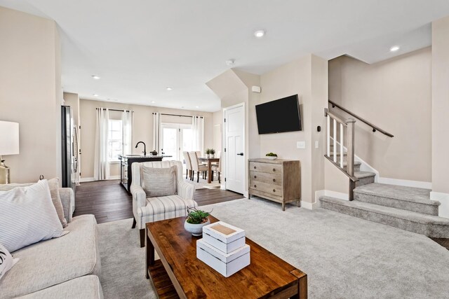 living room with sink and dark hardwood / wood-style floors