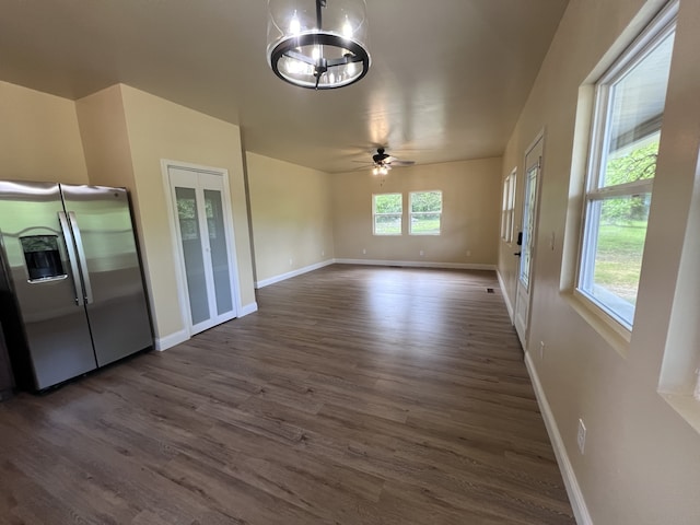 interior space with ceiling fan with notable chandelier and dark hardwood / wood-style floors