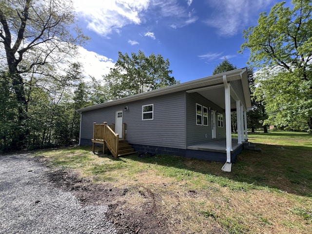 back of property featuring a lawn