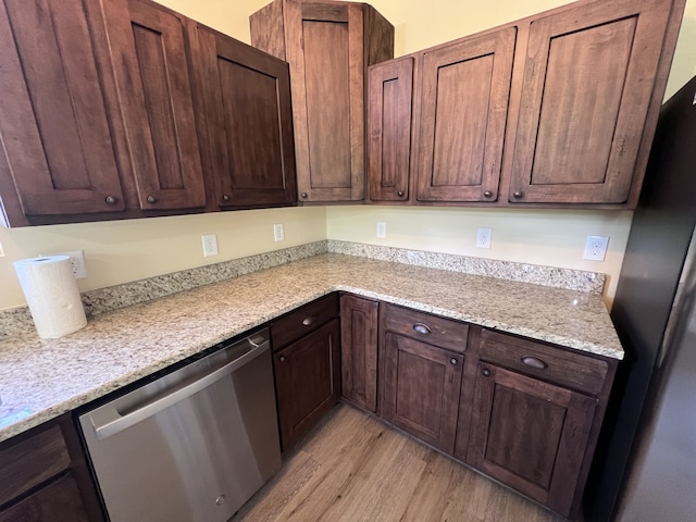 kitchen with light hardwood / wood-style flooring, dark brown cabinets, stainless steel dishwasher, and light stone counters