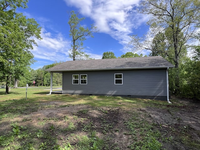 view of side of home with a lawn