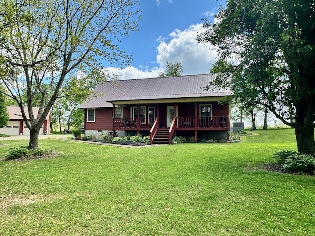 view of front of property featuring central AC and a front lawn