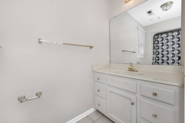 bathroom with vanity with extensive cabinet space and tile flooring