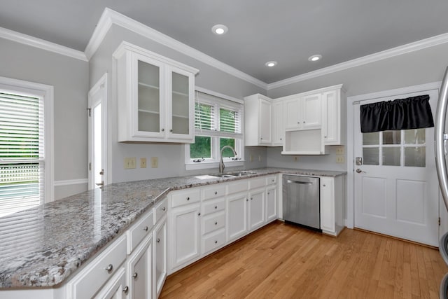 kitchen with white cabinets, sink, light hardwood / wood-style floors, stainless steel dishwasher, and ornamental molding