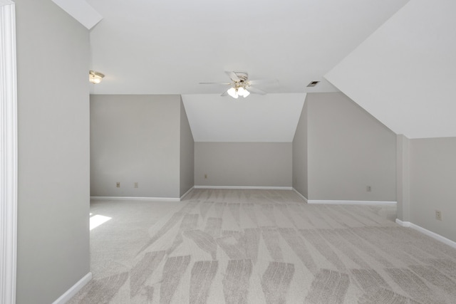 additional living space featuring light carpet, lofted ceiling, and ceiling fan