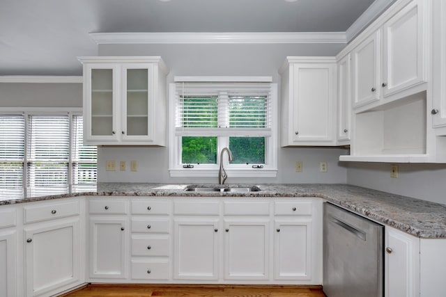 kitchen featuring stainless steel dishwasher, sink, light hardwood / wood-style floors, and white cabinetry