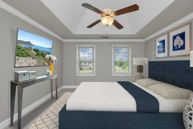 bedroom featuring crown molding, light carpet, ceiling fan, and a raised ceiling