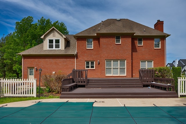 rear view of property with a swimming pool side deck