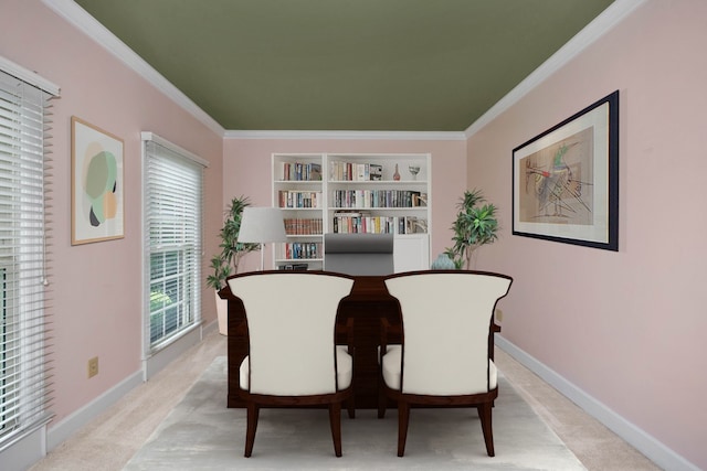 carpeted dining area featuring crown molding