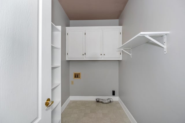 clothes washing area with cabinets, hookup for a washing machine, and light tile floors