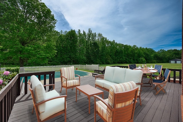 wooden terrace featuring an outdoor living space and a covered pool