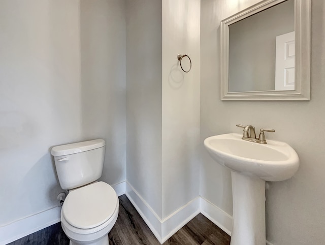 bathroom featuring wood-type flooring and toilet