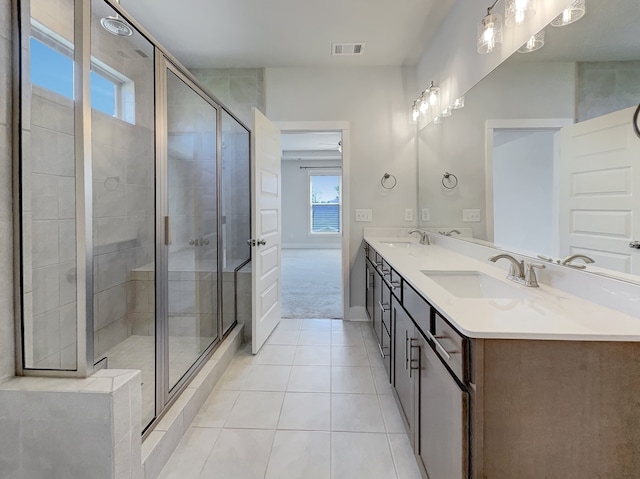 bathroom with large vanity, an enclosed shower, tile floors, and double sink