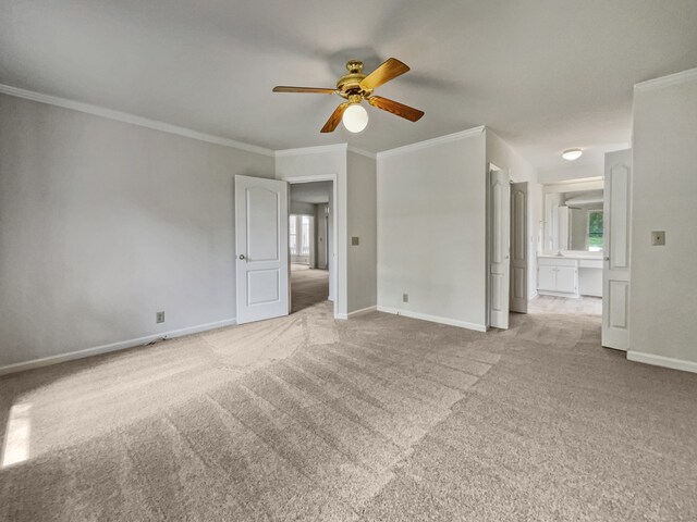 carpeted empty room with ceiling fan and ornamental molding