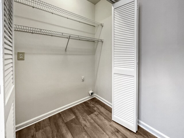 laundry room featuring dark wood-type flooring and electric dryer hookup