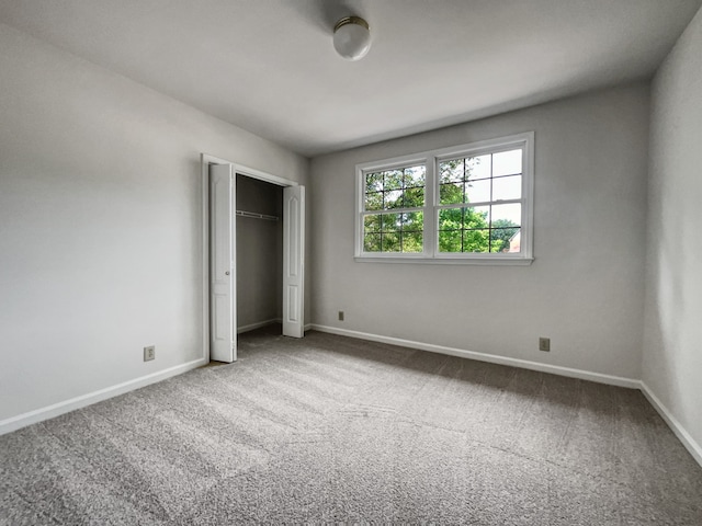 unfurnished bedroom featuring carpet flooring and a closet