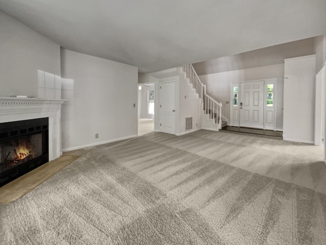 unfurnished living room featuring carpet floors