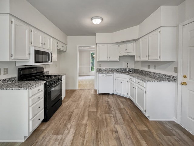 kitchen featuring wood-type flooring, white cabinets, white appliances, and sink