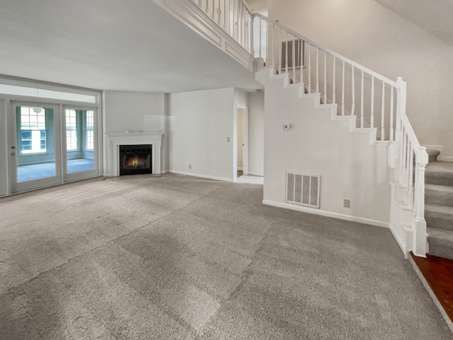 unfurnished living room with carpet flooring