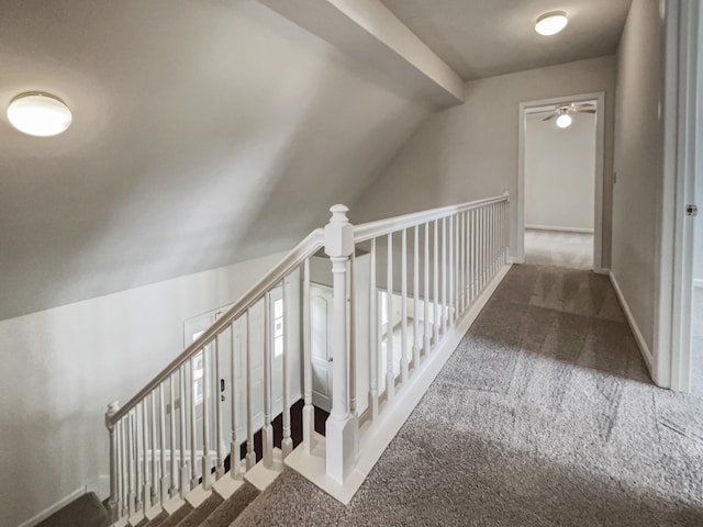 interior space with vaulted ceiling, ceiling fan, and dark colored carpet