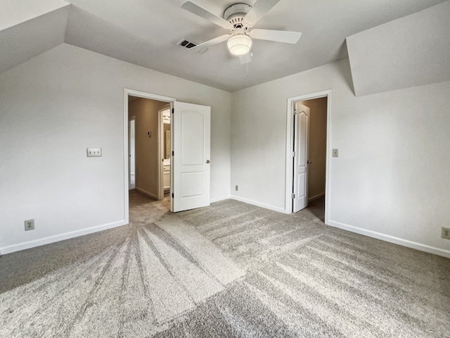 spare room with vaulted ceiling, ceiling fan, and carpet flooring