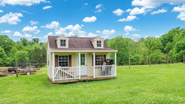 cape cod house with covered porch and a front lawn