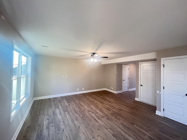 unfurnished room featuring ceiling fan and dark wood-type flooring