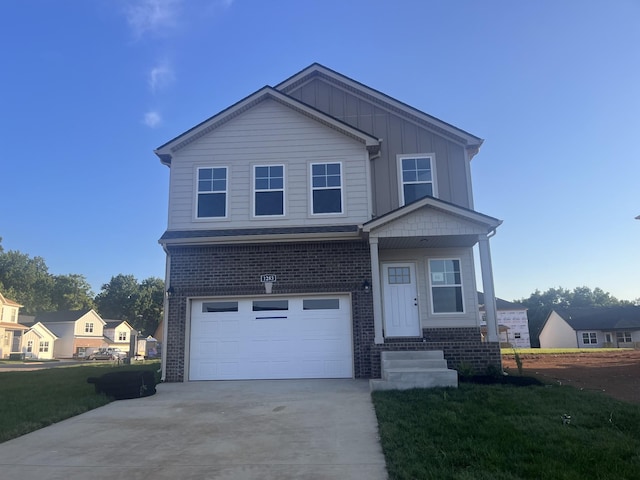 view of front of home with a front yard and a garage