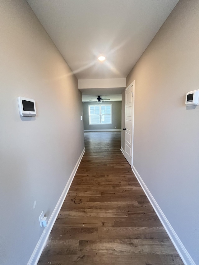 hallway with dark wood-type flooring