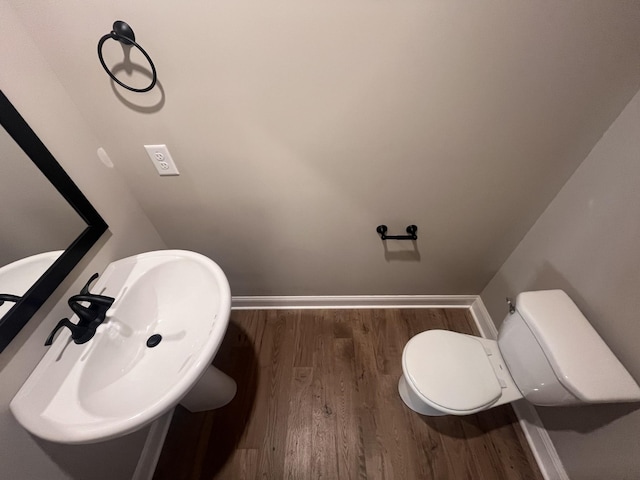 bathroom featuring hardwood / wood-style floors, toilet, and sink