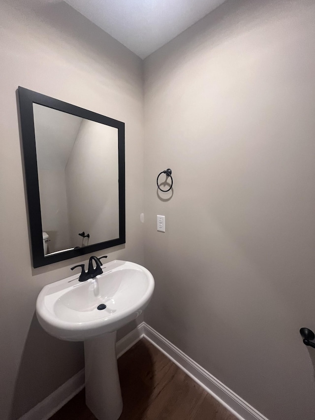 bathroom with hardwood / wood-style floors and toilet