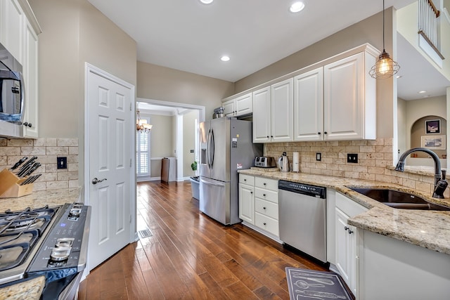 808 Seven Points Cv, Hermitage, TN 37076 - kitchen with stainless steel appliances, white cabinets, decorative light fixtures, backsplash, and sink
