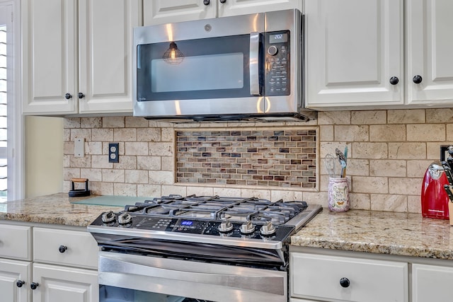 808 Seven Points Cv, Hermitage, TN 37076 - kitchen featuring stainless steel appliances, tasteful backsplash, and white cabinetry