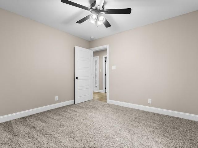 carpeted empty room featuring ceiling fan